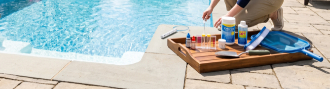 Pool water testing products and test strips used in spring to balance the pH before the first swim.